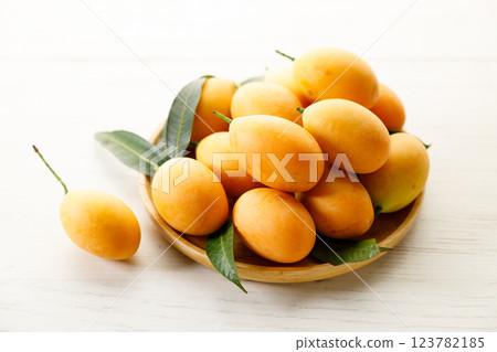 Plum Mango or Marian Plum fruit in wooden tray. Plum Mango or Marian Plum fruit in wooden tray. 123782185