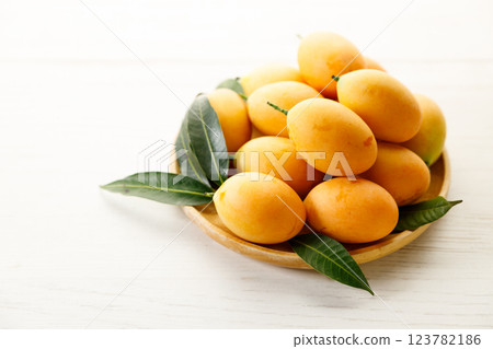 Plum Mango or Marian Plum fruit in wooden tray. Plum Mango or Marian Plum fruit in wooden tray. 123782186