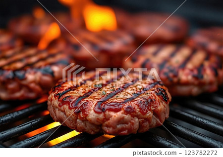 Succulent Flame-Grilled Gourmet Beef Patties Sizzling on Open Barbecue with Rising Flames A Culinary Masterpiece in Premium Food Photography 123782272