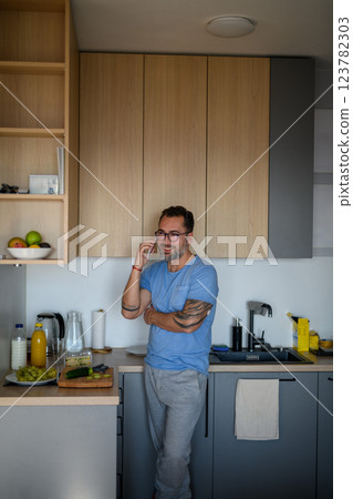 Diabetic man with CGM sensor making phone call. 123782303