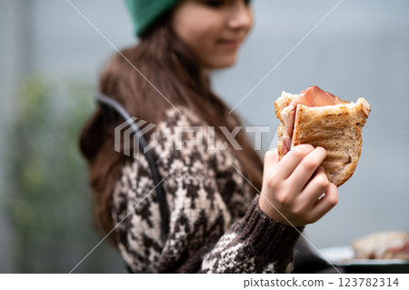 Girl enjoying a homemade baked sandwich with bacon. Girl enjoying a homemade baked sandwich with bacon. 123782314