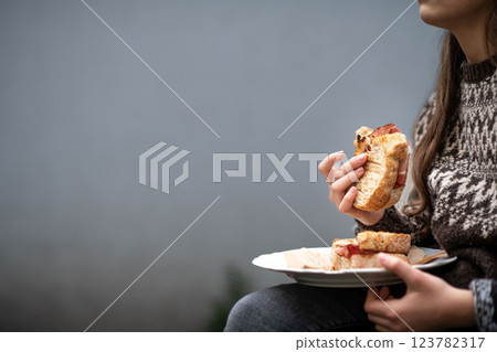 Girl enjoying a homemade baked sandwich with bacon. 123782317