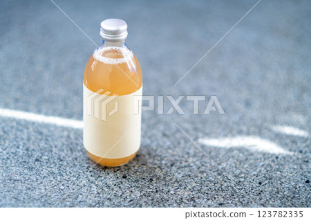Glass bottle with kombucha. Handmade apple juice in bottle. 123782335