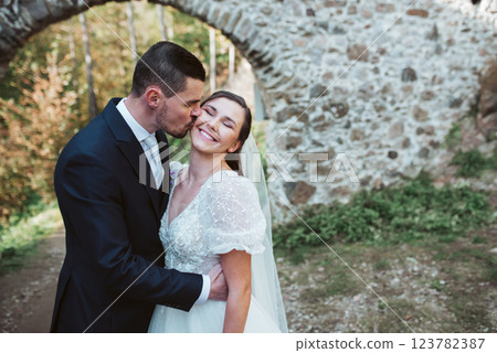Groom kissing beautiful bride on cheek. Groom kissing beautiful bride on cheek. 123782387