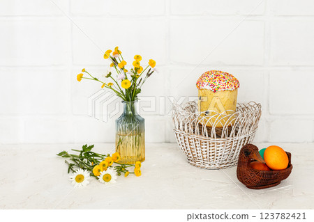 Easter cake and colored Easter eggs in the wicker baskets. Easter cake and colored Easter eggs in the wicker baskets. 123782421