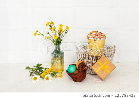 Easter cake and colored Easter eggs in the wicker baskets. 123782422