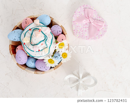 Easter cake and colorful Easter eggs in the wooden basket. 123782431