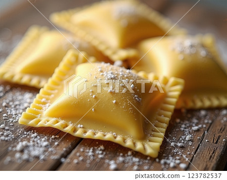 Artisanal Italian Handcrafted Ravioli Pasta with Traditional Crimped Edges on Rustic Wooden Surface A Culinary Craftsmanship Display Artisanal Italian Handcrafted Ravioli Pasta with Traditional Crimped Edges on Rustic Wooden Surface A Culinary Craftsmanship Display 123782537