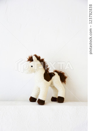Beige and brown stuffed horse doll photographed against a white background Beige and brown stuffed horse doll photographed against a white background 123782838