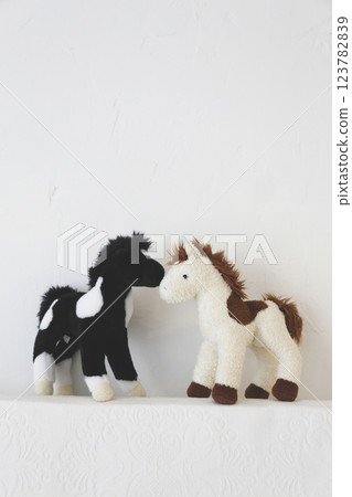A pair of stuffed horses photographed against a white background A pair of stuffed horses photographed against a white background 123782839