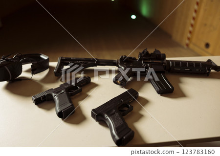 Pistols and assault weapons at shooting range used to train and test soldiers on necessary combat skills. Rifles and handguns to be used by army soldiers training to enhance combat readiness Pistols and assault weapons at shooting range used to train and test soldiers on necessary combat skills. Rifles and handguns to be used by army soldiers training to enhance combat readiness 123783160