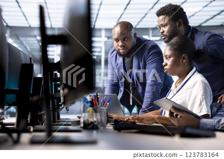 Team of data center office technicians using programming languages to construct algorithms and build applications. Server hub IT staff members debugging and optimizing code Team of data center office technicians using programming languages to construct algorithms and build applications. Server hub IT staff members debugging and optimizing code 123783164