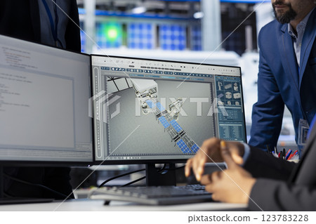 Solar panel manufacturing plant manager checking progress done by technician programming industrial systems developing tools to track and improve equipment performance, close up Solar panel manufacturing plant manager checking progress done by technician programming industrial systems developing tools to track and improve equipment performance, close up 123783228