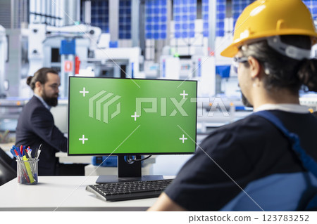 Photovoltaics facility worker reviewing efficiency metrics on green screen computer to improve production output. Solar panels plant specialist identifying system errors using chroma key PC 123783252