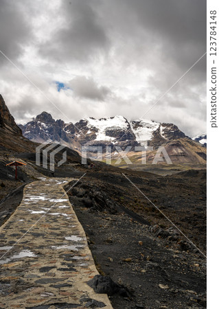 Stone trail leading to Pastoruri Glacier, Huaraz, Peru, amidst rugged mountains 123784148