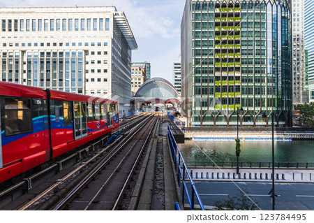 DLR Train Passing Through Canary Wharf with Modern Skyscrapers 123784495