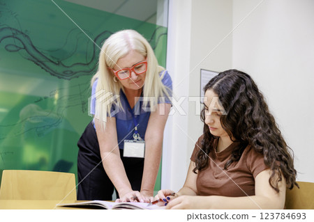 Girl studying with teacher Girl studying with teacher 123784693