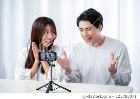 Men and women taking videos with smartphones 123785071