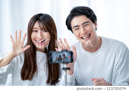 Men and women taking videos with smartphones Men and women taking videos with smartphones 123785074