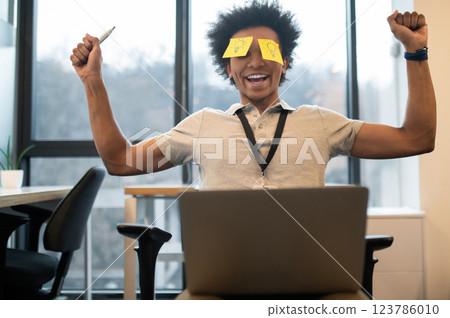 Businessman with yellow sticker on his face in modern office 123786010