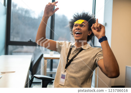 Man with yellow notes on face having fun in office Man with yellow notes on face having fun in office 123786016