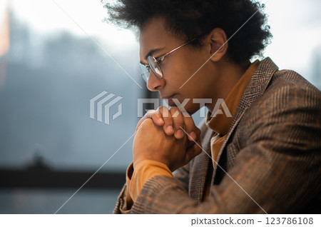 Businessman sitting at the laptop with a serious look and thinking 123786108