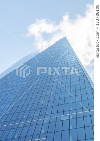 Tall glass skyscrapers tower above, reflecting the sky and clouds in the City of London. The architecture showcases modern design in one of the world's key financial centers. 123786109