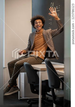 Young businessman looking confident and contented in the office Young businessman looking confident and contented in the office 123786123