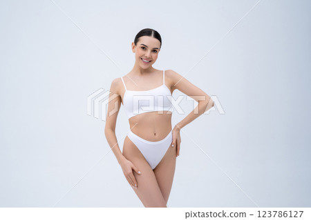 Pretty young caucasian woman in white underwear on a white background Pretty young caucasian woman in white underwear on a white background 123786127