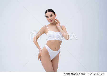 Pretty young caucasian woman in white underwear on a white background Pretty young caucasian woman in white underwear on a white background 123786128