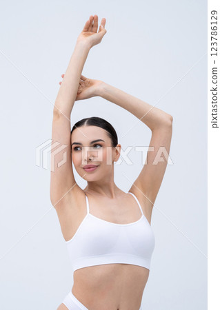 Pretty young caucasian woman in white underwear on a white background Pretty young caucasian woman in white underwear on a white background 123786129
