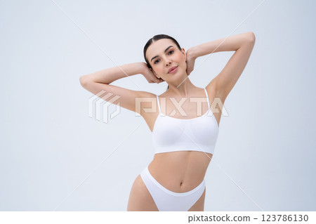 Pretty young caucasian woman in white underwear on a white background Pretty young caucasian woman in white underwear on a white background 123786130