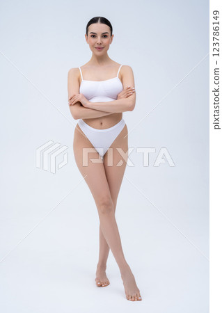 Pretty long-haired young caucasian woman in white underwear Pretty long-haired young caucasian woman in white underwear 123786149