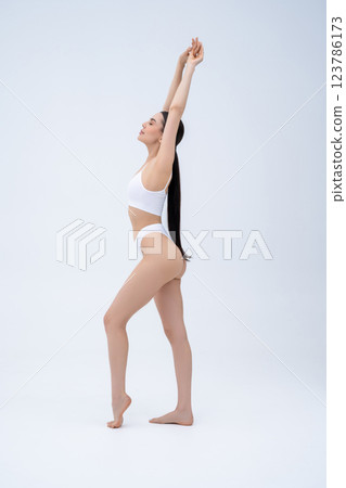 Slim beautiful young woman in white lingerie in a white background 123786173