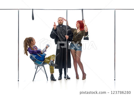 Priest, businesswoman and partygoer exchanging curious glances while standing in public setting against white background. 123786280