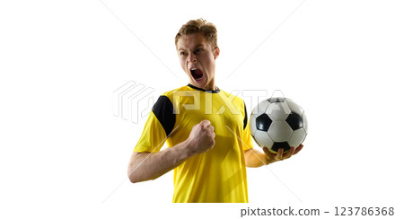 Emotional man, soccer player in yellow jersey holding ball and shouting in excitement, motivation to win. White background. Emotional man, soccer player in yellow jersey holding ball and shouting in excitement, motivation to win. White background. 123786368