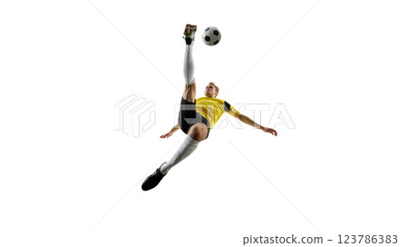 Focused man, soccer player executing overhead kick, dynamically kicking ball in air and falling down against white background. Focused man, soccer player executing overhead kick, dynamically kicking ball in air and falling down against white background. 123786383