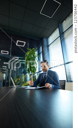 Visionary entrepreneur writing strategies, reviewing corporate goals, and managing workflow in office. Visionary entrepreneur writing strategies, reviewing corporate goals, and managing workflow in office. 123786442