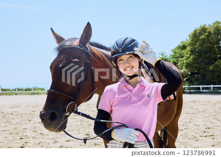 Woman practicing horse riding 123786991