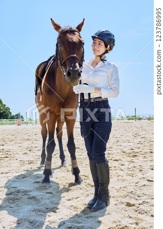 Woman practicing horse riding Woman practicing horse riding 123786995