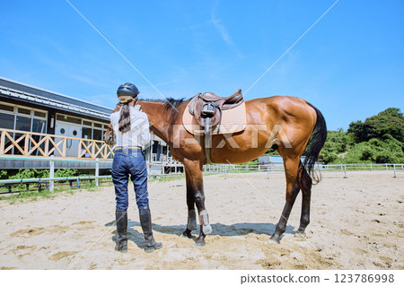 Woman practicing horse riding 123786998
