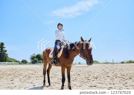 A woman practicing horse riding 123787020