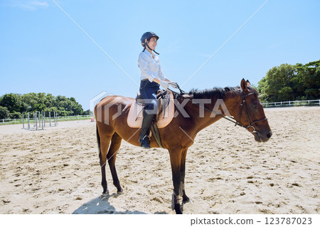 A woman practicing horse riding 123787023