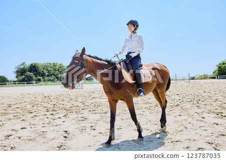 A woman practicing horse riding A woman practicing horse riding 123787035