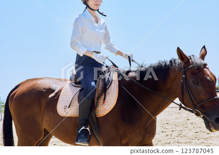 A woman practicing horse riding 123787045