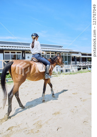 A woman practicing horse riding A woman practicing horse riding 123787049