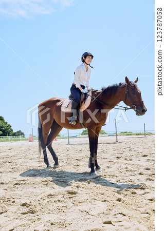 A woman practicing horse riding 123787058