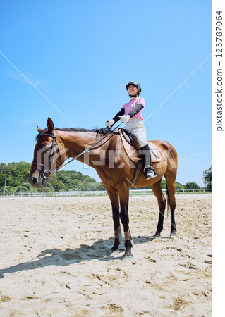 A woman practicing horse riding 123787064