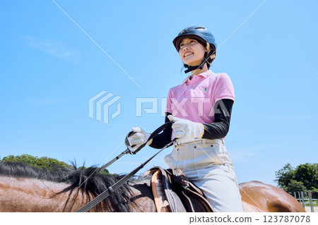 A woman practicing horse riding 123787078