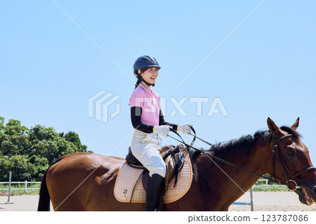 A woman practicing horse riding 123787086